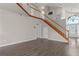 Spacious living room featuring hardwood floors and wooden staircase at 6150 Half Moon Dr, Port Orange, FL 32127