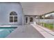Outdoor patio with a screened enclosure and a view of the pool and backyard at 6150 Half Moon Dr, Port Orange, FL 32127