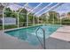Enclosed pool with clear blue water, patio, and lush landscaping at 6150 Half Moon Dr, Port Orange, FL 32127