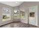 Sunroom filled with natural light, offering a view of the backyard and access to the outdoor patio at 6150 Half Moon Dr, Port Orange, FL 32127