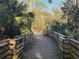 Wooden walkway surrounded by lush tropical greenery at 6150 Half Moon Dr, Port Orange, FL 32127