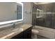 This bathroom features a granite countertop, tiled shower, and illuminated mirror at 6301 Swanson St, Windermere, FL 34786