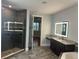 Bathroom features a frameless glass shower, lighted mirror, and granite countertops at 6301 Swanson St, Windermere, FL 34786