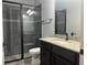 Modern bathroom featuring glass enclosed shower with dark fixtures and granite vanity at 6301 Swanson St, Windermere, FL 34786