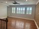 Bonus room with wood floors, plantation shutters, and a decorative brick accent wall at 6301 Swanson St, Windermere, FL 34786