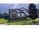 Charming two-story home with a stone-accented facade, manicured lawn, and paved driveway at 6301 Swanson St, Windermere, FL 34786