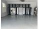 This garage has epoxy flooring, storage racks, and a ceiling fan at 6301 Swanson St, Windermere, FL 34786