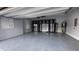 Garage with epoxy floor, built in storage, utility sink, and overhead fan and light at 6301 Swanson St, Windermere, FL 34786
