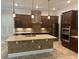 Beautiful kitchen island with stone counters and stainless appliances at 6301 Swanson St, Windermere, FL 34786