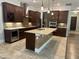 Gourmet kitchen boasts custom cabinets, granite counters, stainless appliances, and tile backsplash at 6301 Swanson St, Windermere, FL 34786