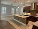 Spacious kitchen featuring a large island, stainless steel appliances, and custom cabinetry at 6301 Swanson St, Windermere, FL 34786