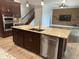 Open concept kitchen with stainless appliances, granite counters and an island at 6301 Swanson St, Windermere, FL 34786