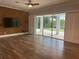 Bright living room featuring sliding glass doors to the backyard and a unique brick accent wall at 6301 Swanson St, Windermere, FL 34786