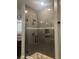 Modern glass enclosed shower featuring tiled walls and a rainfall showerhead at 6301 Swanson St, Windermere, FL 34786