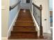 Beautiful staircase with wooden steps, decorative iron spindles, and a matching wood railing at 6301 Swanson St, Windermere, FL 34786