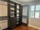 Custom walk-in closet with dark wood shelving, drawers, and hanging space at 6301 Swanson St, Windermere, FL 34786