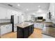 Modern kitchen with white cabinetry, granite countertops, and a black center island at 7462 Aprelle Dr, Sanford, FL 32771