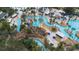 Aerial view of the community featuring a winding lazy river, pools, water slides and lush landscaping at 7740 Sandy Ridge Dr # 206, Kissimmee, FL 34747