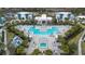 Aerial view of the complex featuring a large pool, lounge chairs, cabanas, and contemporary-style buildings at 7740 Sandy Ridge Dr # 206, Kissimmee, FL 34747