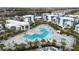Aerial view of complex featuring a large pool, lounge chairs, umbrellas, and modern architecture at 7740 Sandy Ridge Dr # 206, Kissimmee, FL 34747
