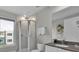 Modern bathroom featuring a glass-enclosed shower with rain shower head, window, and vanity with countertop at 7740 Sandy Ridge Dr # 206, Kissimmee, FL 34747