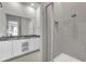 Modern bathroom with a glass-enclosed shower and double sinks, offering a sleek and functional design at 7740 Sandy Ridge Dr # 206, Kissimmee, FL 34747