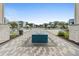 Modern community pool with a blue tiled fountain, palm trees, cabanas and plenty of seating for residents to enjoy at 7740 Sandy Ridge Dr # 206, Kissimmee, FL 34747
