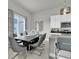 Dining area adjacent to kitchen with large window and modern pendant lighting at 7740 Sandy Ridge Dr # 206, Kissimmee, FL 34747