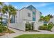 Modern condo complex exterior with white fence, palm trees, and blue accents at 7740 Sandy Ridge Dr # 206, Kissimmee, FL 34747
