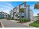 Beautiful modern condo building with lush landscaping and a blue and gray color scheme at 7740 Sandy Ridge Dr # 206, Kissimmee, FL 34747