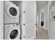 Conveniently located laundry room with a stacked washer and dryer for space-saving efficiency at 7740 Sandy Ridge Dr # 206, Kissimmee, FL 34747