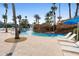 Lounge chairs near waterfall feature in the lazy river, making for a relaxing and luxurious community pool experience at 7740 Sandy Ridge Dr # 206, Kissimmee, FL 34747