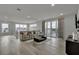 Bright living room with hardwood floors, a sliding glass door to an outdoor balcony, and neutral-toned furniture at 7740 Sandy Ridge Dr # 206, Kissimmee, FL 34747
