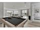 Open floor plan with living room, game room with pool table, and bedroom with ensuite bathroom at 7740 Sandy Ridge Dr # 206, Kissimmee, FL 34747