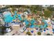 Aerial view of community water park with lazy river, lounge seating and palm trees at 7740 Sandy Ridge Dr # 206, Kissimmee, FL 34747