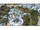 Aerial view of large community water park, lazy river, and complex of new, white and blue residential homes at 7740 Sandy Ridge Dr # 206, Kissimmee, FL 34747