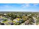 Aerial view featuring a home with lush surroundings and a community lake at 806 Wildwood Cir, Port Orange, FL 32127