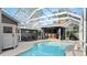 A beautiful screened-in pool with an adjacent outdoor bar and outdoor seating area at 806 Wildwood Cir, Port Orange, FL 32127