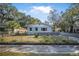 Charming light blue one story home with a fenced yard and a long driveway at 829 Madison Ave, Daytona Beach, FL 32114