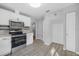 Modern kitchen with stainless steel appliances, white cabinets, and beautiful tile backsplash detail at 829 Madison Ave, Daytona Beach, FL 32114