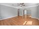Sun-filled living room featuring hardwood floors, ceiling fan, and open archways at 829 Madison Ave, Daytona Beach, FL 32114