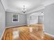 Spacious living room featuring pristine hardwood floors and a elegant chandelier at 829 Madison Ave, Daytona Beach, FL 32114