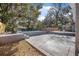 Backyard showcasing the fenced pool, concrete pool deck and partial home exterior at 829 Madison Ave, Daytona Beach, FL 32114