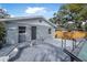 Back exterior view of the home featuring an in-ground pool, back door and fenced yard at 829 Madison Ave, Daytona Beach, FL 32114