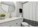 Modern bathroom with stylish vanity, decorative mirror, and shower with a striped curtain at 840 Center Ave # 9, Daytona Beach, FL 32117