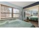 Bedroom with mirrored closet doors, wood look flooring, and soothing light blue walls at 840 Center Ave # 9, Daytona Beach, FL 32117