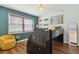 Charming bedroom featuring a playful design and a cozy yellow chair, perfect for relaxation and study at 840 Center Ave # 9, Daytona Beach, FL 32117