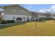 Scenic view of condo building with lush green lawn and mature trees under a bright blue sky at 840 Center Ave # 9, Daytona Beach, FL 32117