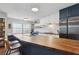 Open kitchen concept with butcher block counters, island seating and stainless steel appliances at 840 Center Ave # 9, Daytona Beach, FL 32117