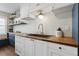 Bright kitchen featuring white shaker cabinets, brass hardware, and butcher block countertops at 840 Center Ave # 9, Daytona Beach, FL 32117